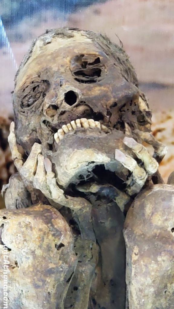mummie holding face